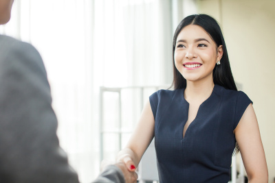 Asian businesswoman shaking hands